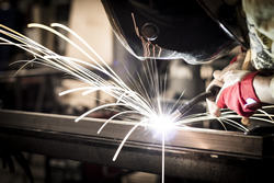 capabilities - technician welding with sparks flying