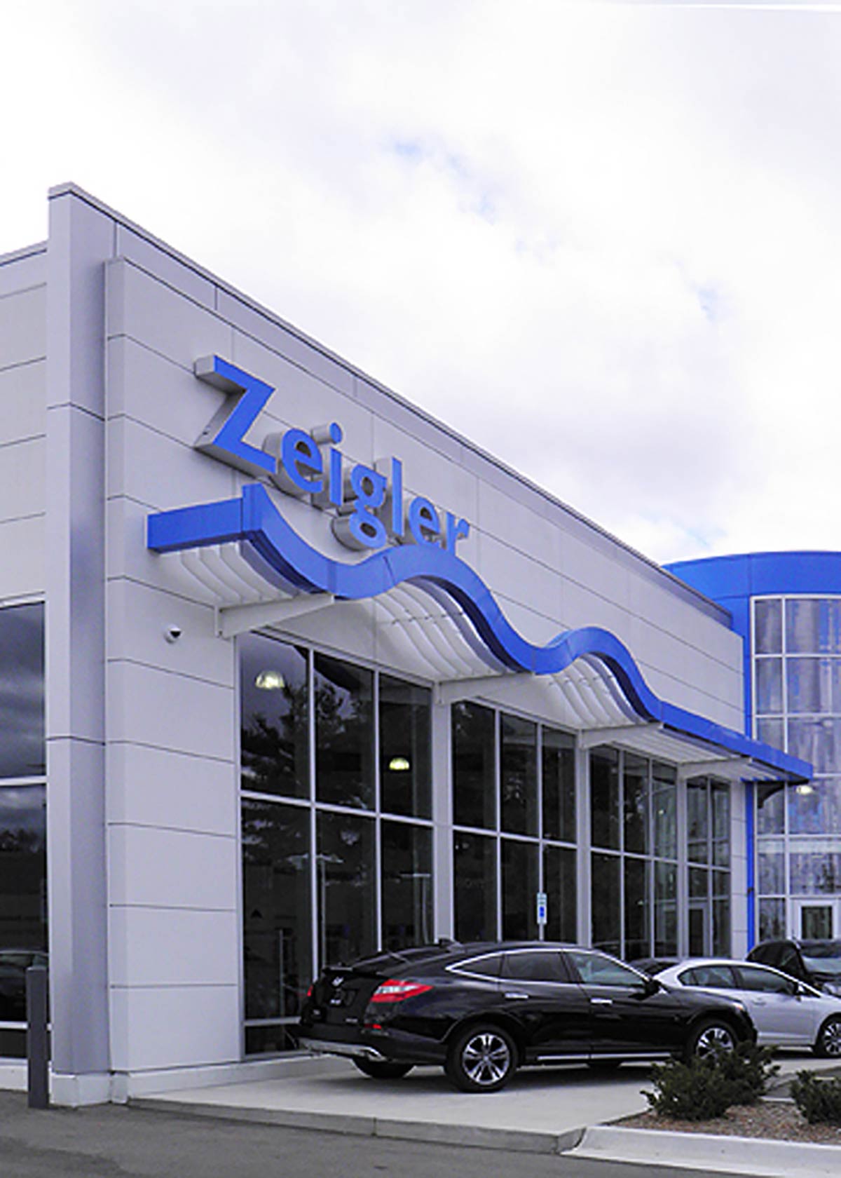 dealership front with automotive sign