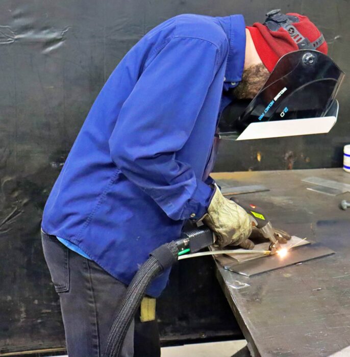 technician doing laser welding